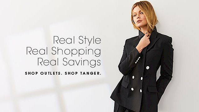 A woman in a stylish black outfit stands beside text promoting outlets and savings: "Real Style, Real Shopping, Real Savings. Shop Tanger."